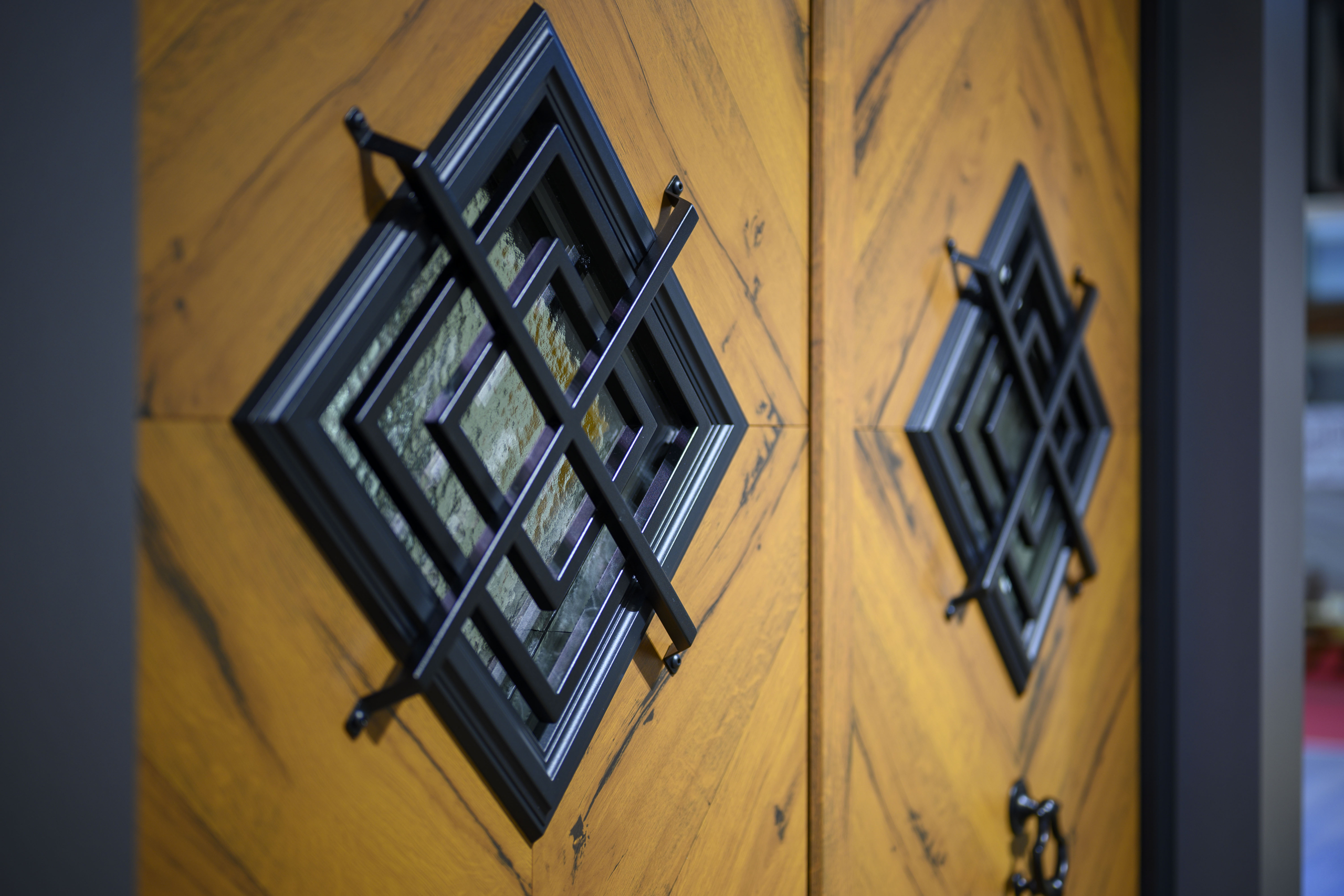 Diamond-pattern glazed inserts and metal frames on wood-effect front doors