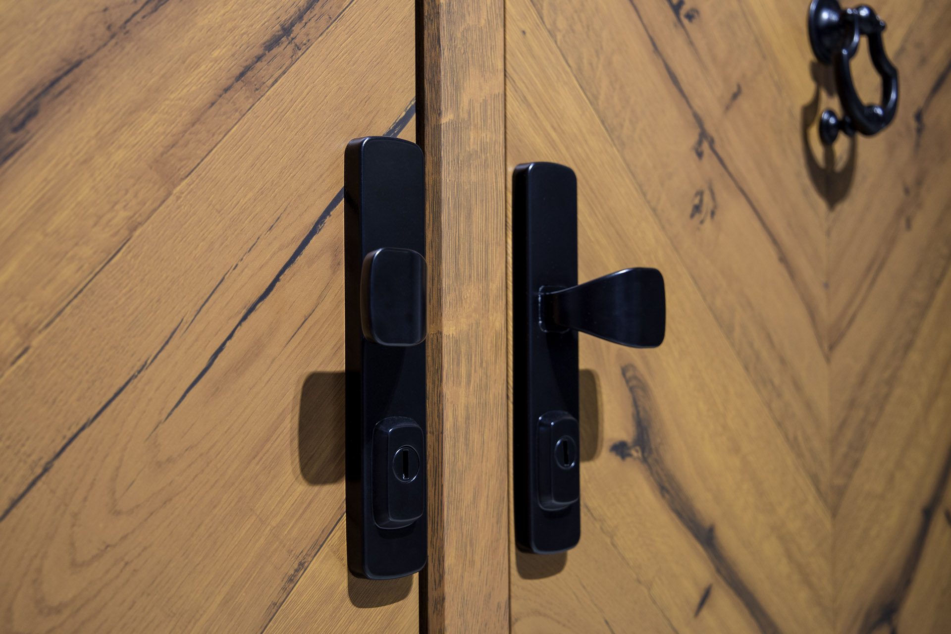 Traditional black handle on a wood-effect front door