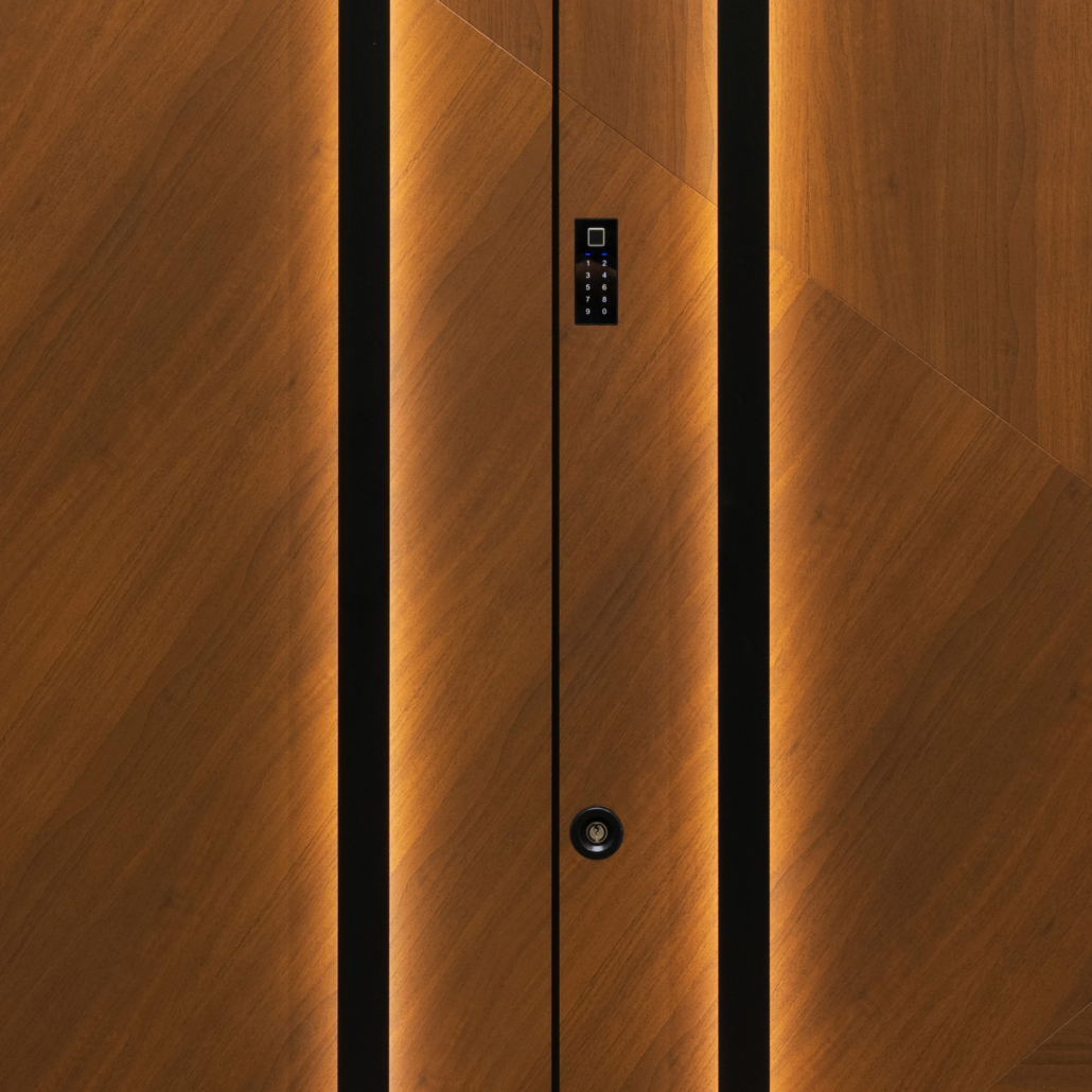 Front door in a wood finish with two black pull handles and LED lighting