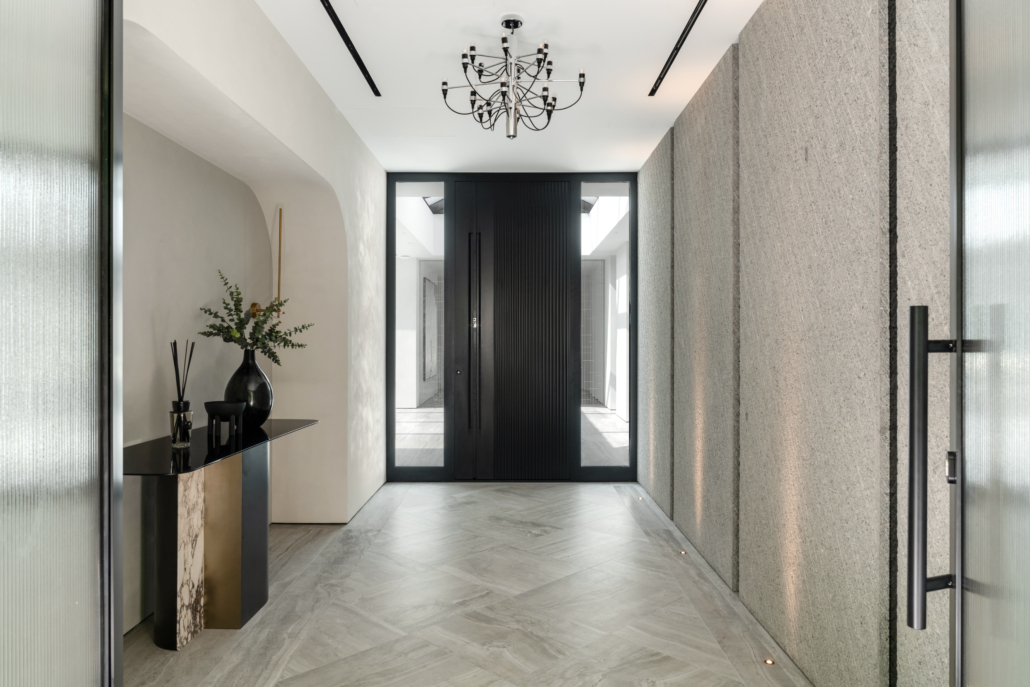 Modern building with a black front door and side lights