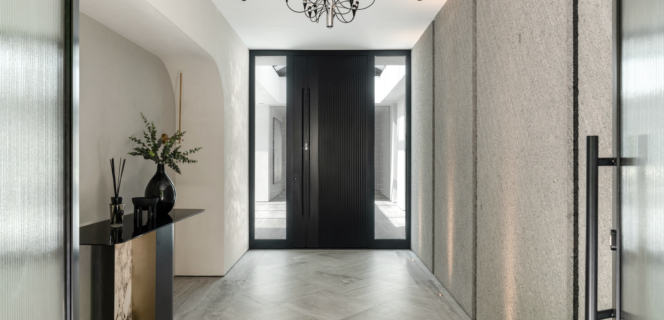 Modern building with a black front door and side lights