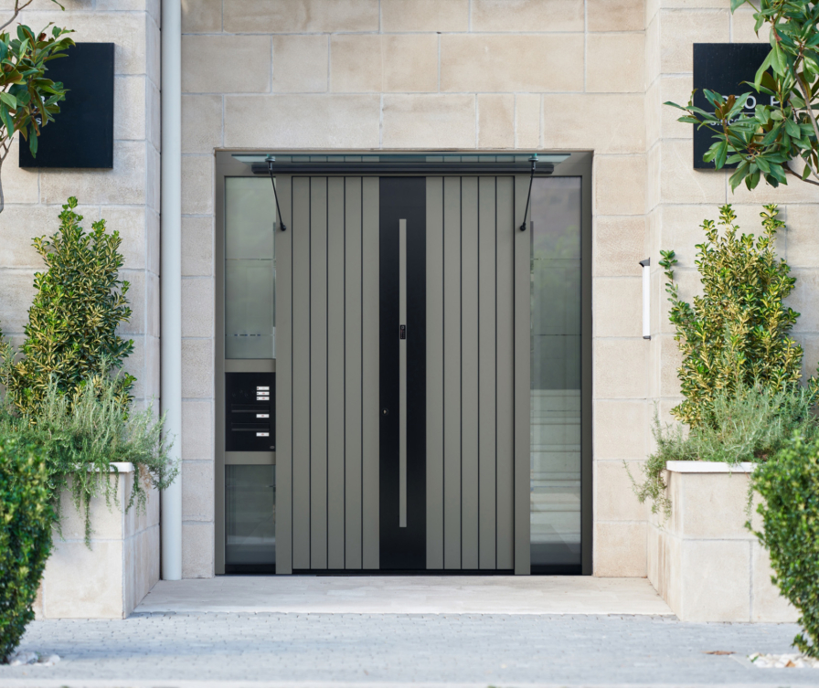 Grey and black front door with side panel, canopy and letterbox