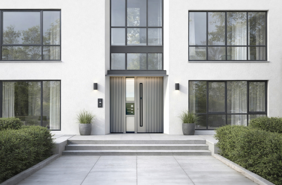 Multi-family residential building with large glazed surfaces and grey entrance doors