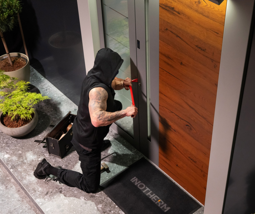 Burglar attempting to break into a front door