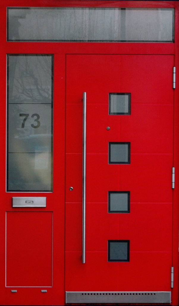 Old image of a red entrance door with glass, a letter slot and a house number