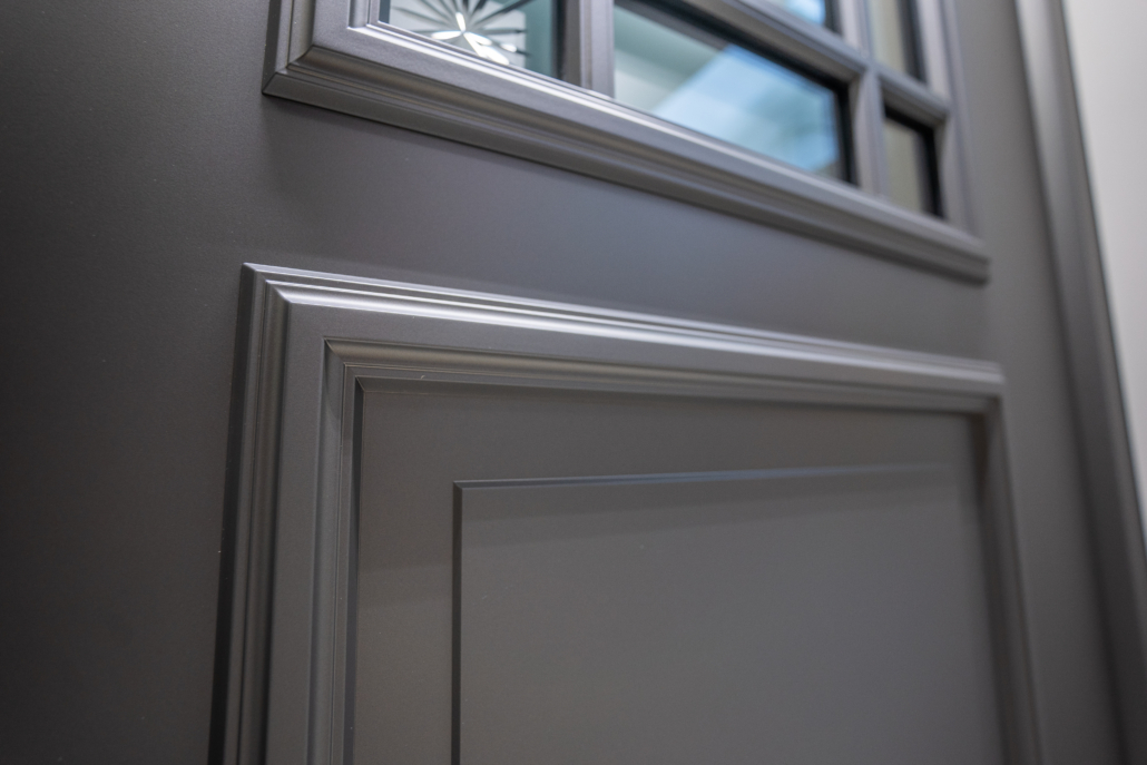 Decorative detail with accentuated frames on a grey front door
