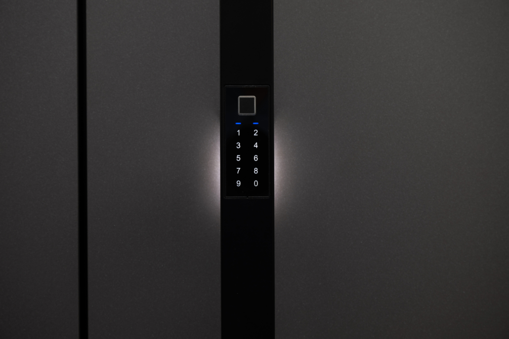 Black door handle with the integrated Inosmart smart access system on a dark front door